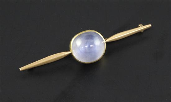 A gold and cabochon pale blue star sapphire bar brooch, 2.25in.